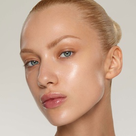 Model wearing Kylie Cosmetics Makeup Primer, showcasing a dewy, glass-skin complexion finish with natural, luminous coverage.