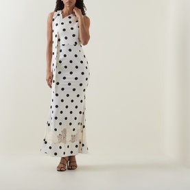 Model wearing Lavish Alice Black/White polka dot maxi dress with lace hem detail, styled with brown strappy heels