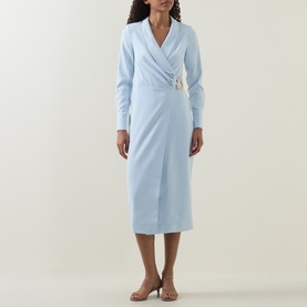 Model wearing Lavish Alice blue long-sleeve wrap midi dress with gold buckle detail, styled with nude heeled sandals