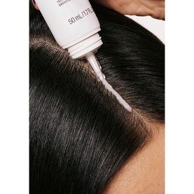 Olaplex The Healthy Hair Discovery Set nozzle applicator dispensing serum directly onto dark hair scalp
