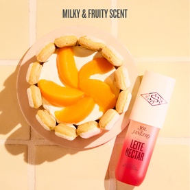 Sol De Janeiro Leite Nectar Perfume Mist bottle styled with peach slices and ladyfinger biscuits, highlighting milky fruity scent