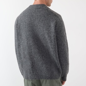 Model wearing A.P.C. heathered anthracite wool-alpaca crew neck sweater, rear view, styled with olive trousers