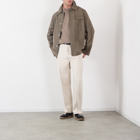 Model wearing A.P.C. Taupe Crew Neck knit, styled with olive overshirt, cream trousers and dark loafers
