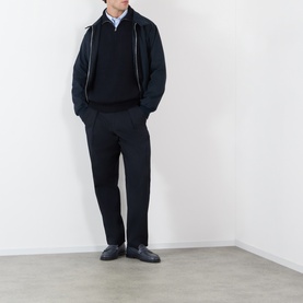 Model wearing A.P.C. dark navy virgin wool knitwear half-zip jumper, styled with navy trousers, light blue shirt and black loafers.