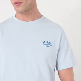 Model wearing A.P.C. T-shirt in light blue with small blue embroidered logo print to chest.