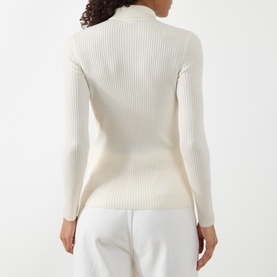 Model wearing Akris Punto cream ribbed wool cardigan, back view, styled with white wide-leg trousers