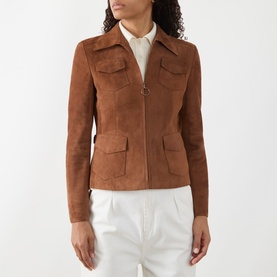 Model wearing Akris Punto hazel suede goat leather jacket with zip front, four flap pockets, styled with white shirt and trousers.