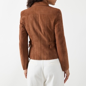 Model wearing Akris Punto hazel suede goat leather jacket, back view, styled with white trousers