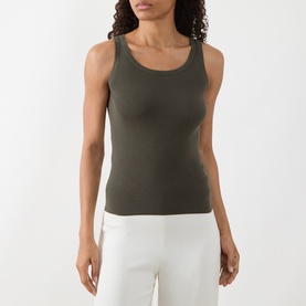 Model wearing Akris Punto olive cotton knit sleeveless tank top, styled with white trousers