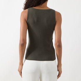 Model wearing Akris Punto olive cotton knit sleeveless top, back view, styled with white wide-leg trousers