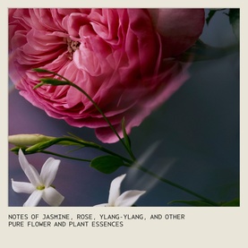 Aveda lifestyle shot featuring pink roses and white jasmine blooms with text noting jasmine, rose, and ylang-ylang flower essences
