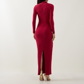 Model wearing Club London red long-sleeve maxi dress, rear view showing fitted silhouette and back split, styled with gold heeled sandals.