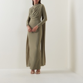 Model wearing Club London olive maxi dress with draped cowl neckline, long sleeves, and cape detail, styled with strappy heeled sandals.