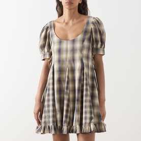 Model wearing Damson Madder Dress in Cardamon Mix Check; puff sleeves, scoop neck, pleated skirt with ruffle hem.