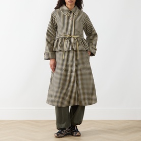 Model wearing Damson Madder Navy Gingham coat with peplum waist and self-belt, styled with khaki wide-leg trousers.