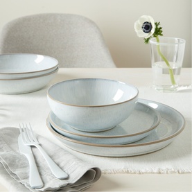 Denby White Speckle Tableware 12-Piece Set in white stoneware, showing stacked dinner plates, medium plates and cereal bowl on a table.