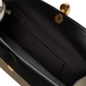 Jacquemus clutch interior in black lamb leather lining with card slot and gold-tone clasp hardware detail visible at top
