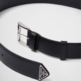 Prada Accessories black leather belt with silver-tone pin buckle and signature triangular logo plaque detail.