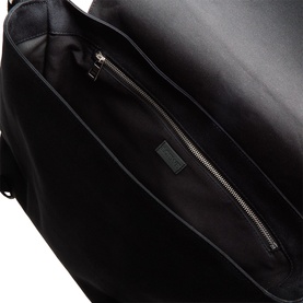 Loewe black canvas and suede bag interior detail showing zip pocket and branded leather patch with silver-tone hardware