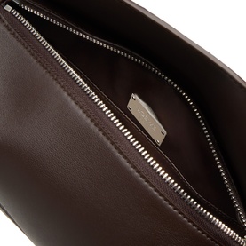 Loewe Puzzle Featherlight Sling Bag in dark chestnut lambskin, open interior view showing silver-tone zip and engraved logo plaque