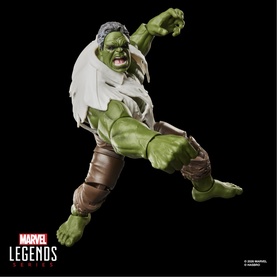 Marvel Legends Hulk action figure in green with torn white shirt and brown trousers, posed mid-leap with fist raised