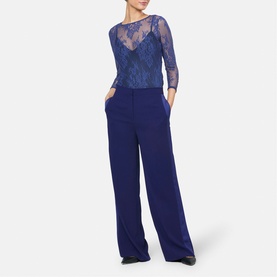 Model wearing Helen McAlinden Ink Blue lace-top wide-leg jumpsuit with sheer three-quarter sleeves and fluid trousers