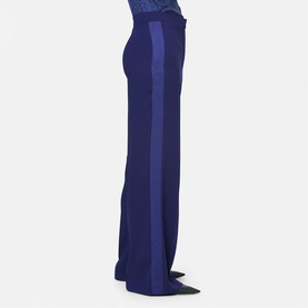 Model wearing Helen McAlinden ink blue wide-leg trousers with contrasting satin side stripe detail, side profile view.