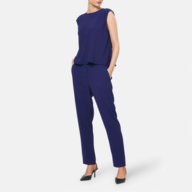 Model wearing Helen McAlinden Ink Blue sleeveless top and matching straight-leg trousers, styled with black pointed-toe heels