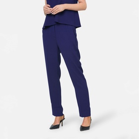 Model wearing Helen McAlinden ink blue tailored straight-leg trousers, styled with matching top and black heeled mules.
