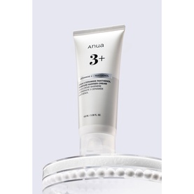 Anua 3+ Day/Night Cream in white tube with minimalist label, displayed on reflective surface with circular dish detail.