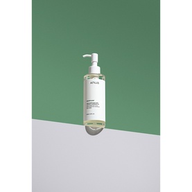 Anua cleanser in clear pump bottle with white cap, displayed against a two-tone green and grey background