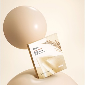 Anua hydrating sheet mask in cream and beige packaging, displayed against soft neutral tones with wheat grain detail