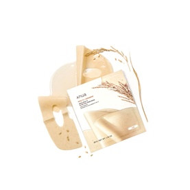 Anua hydrating sheet mask in cream and beige tones, shown unfolded with rice grain botanical detail and serum texture splash