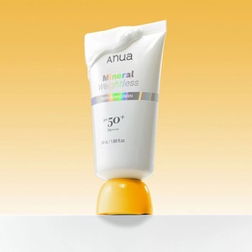 Anua Mineral Weightless Sunscreen SPF50+ white tube with yellow base, standing upright on gradient yellow background