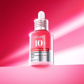 Anua Niacinamide 10 TXA 4 Serum in red glass dropper bottle on pink-red gradient background