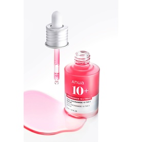 Anua Niacinamide 10 + TXA 4 Serum in pink bottle with dropper lid, pink serum pooled on white surface