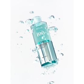 Anua toner in a clear aqua bottle with water droplets, shown floating against a white background with splashing water