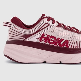 Hoka Bondi 7 running trainer in pink and deep red with knit upper, white midsole, and HOKA logo detail