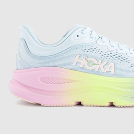 Hoka running trainer in Glimmering Blue Overcast with pastel pink and yellow gradient midsole, mesh upper, logo detail to side.