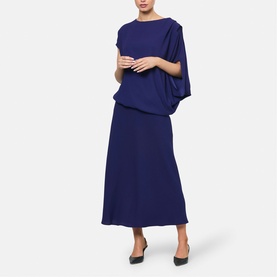 Model wearing Helen McAlinden ink blue draped batwing top and matching midi skirt, styled with black heels