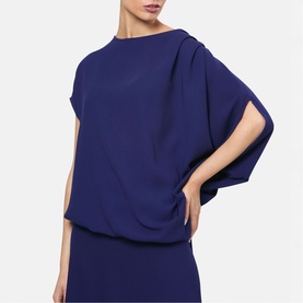 Model wearing Helen McAlinden ink blue relaxed batwing-sleeve top with boat neckline, styled with matching wide-leg trousers