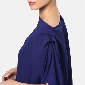 Model wearing Helen McAlinden ink blue top with pleated tulip sleeve detail, close-up shoulder view