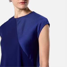 Model wearing Helen McAlinden Ink Blue sleeveless top with layered front panel detail and cap sleeve finish.