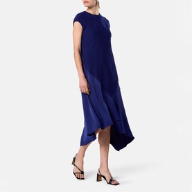 Model wearing Helen McAlinden ink blue midi dress with cap sleeves and asymmetric hi-low hem, styled with black strappy heeled sandals