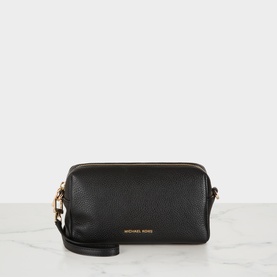 MMK black pebbled leather crossbody bag with gold-tone zip and hardware, wrist strap, on marble surface