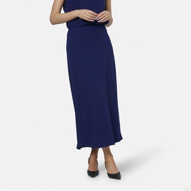 Model wearing Helen McAlinden ink blue midi skirt with bias-cut hem, styled with matching sleeveless top and black heels.