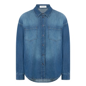 The Frankie Shop Raw Wash denim shirt with dual chest pockets, button-front placket, and curved hem in 100% cotton