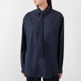 Model wearing The Frankie Shop navy shirt with self-tie neck detail and relaxed oversized silhouette in polyester-wool blend.