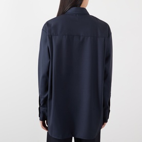Model wearing The Frankie Shop navy oversized shirt, back view, relaxed fit with dropped shoulders and long sleeves