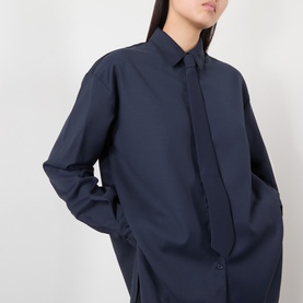Model wearing The Frankie Shop navy oversized shirt with concealed placket, in polyester-wool blend fabric